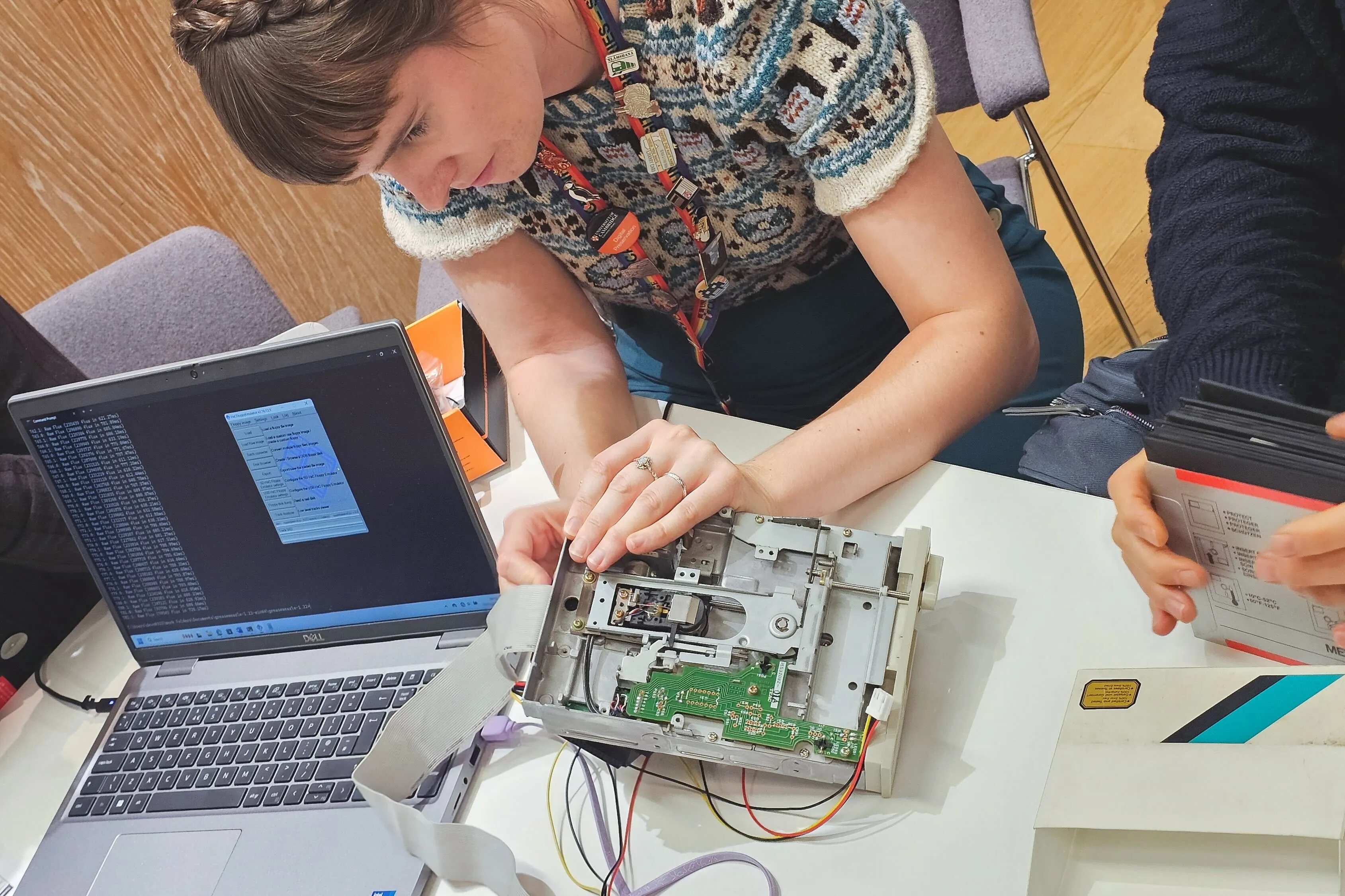 a woman works on a floppy disk drive