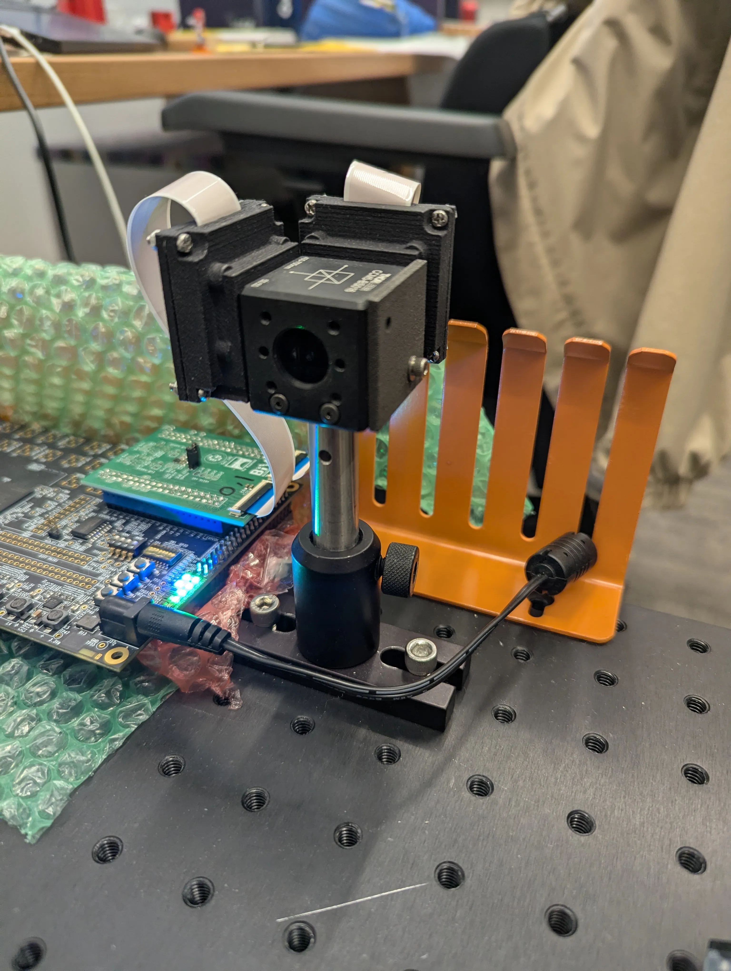 a black boxy camera over a hard drive