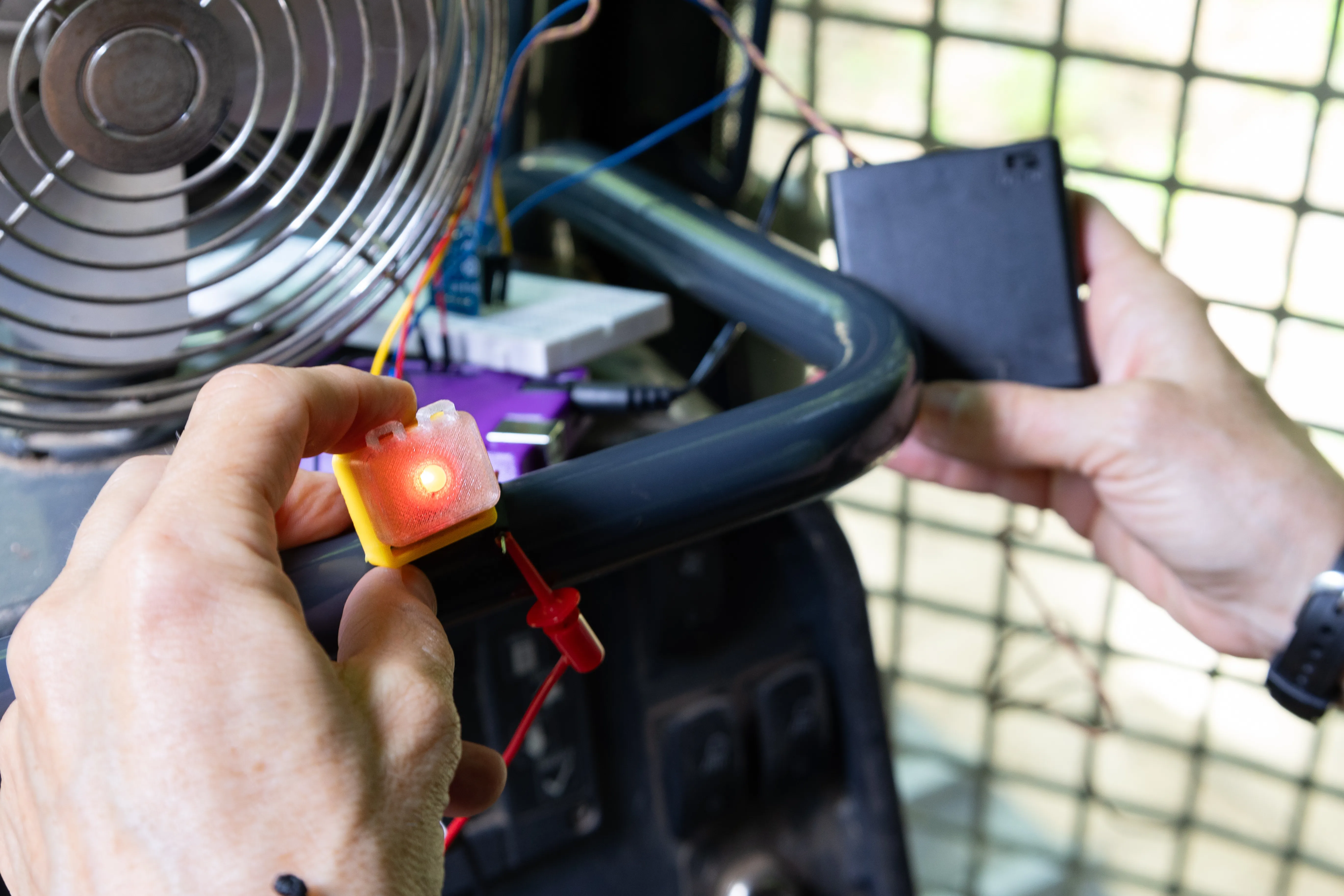 a sensor with a red light being placed on a bullzoser